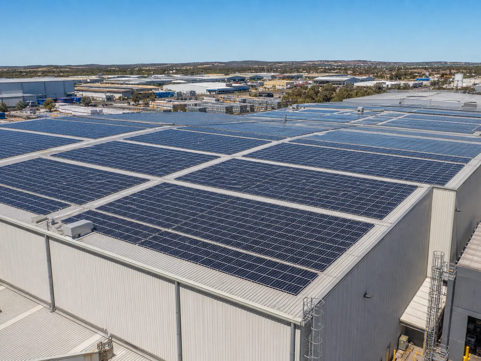 Large commercial solar array across an industrial roof
