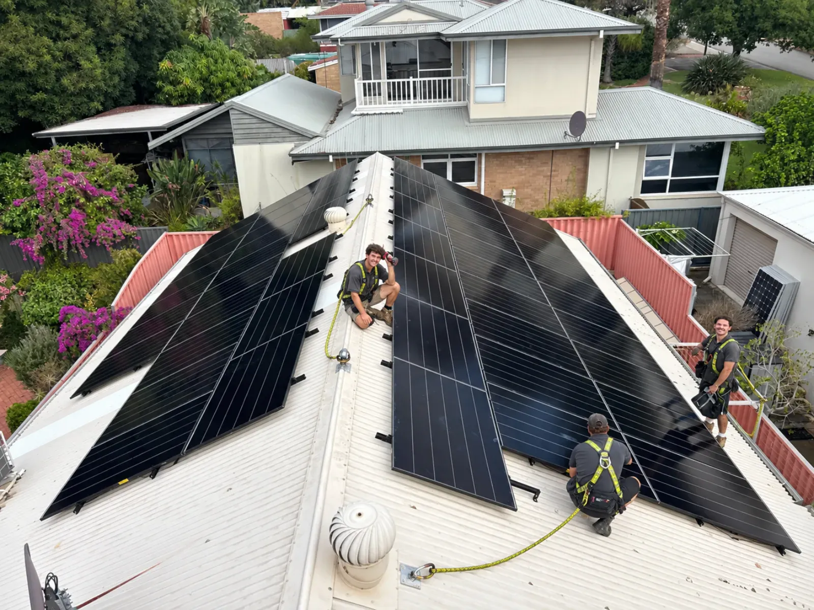 Perth Solar Group crew installing panels on a metal roof